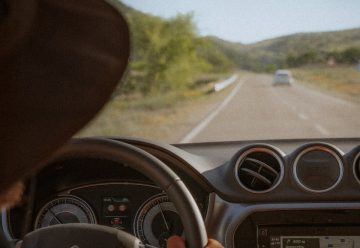 person driving car on road during daytime